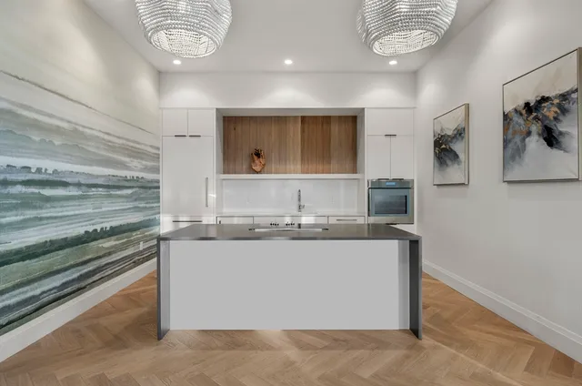a kitchen with stainless steel appliances granite countertop a sink and a stove