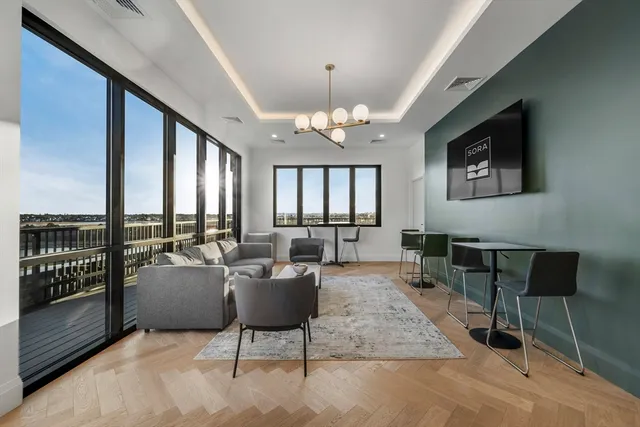 a living room with furniture and a chandelier