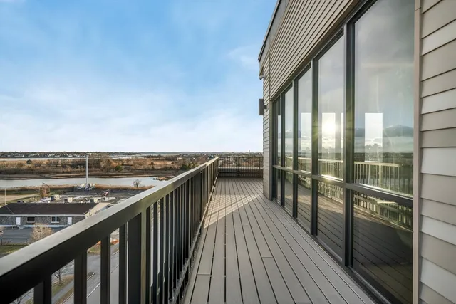 a view of a balcony with wooden floor and fence