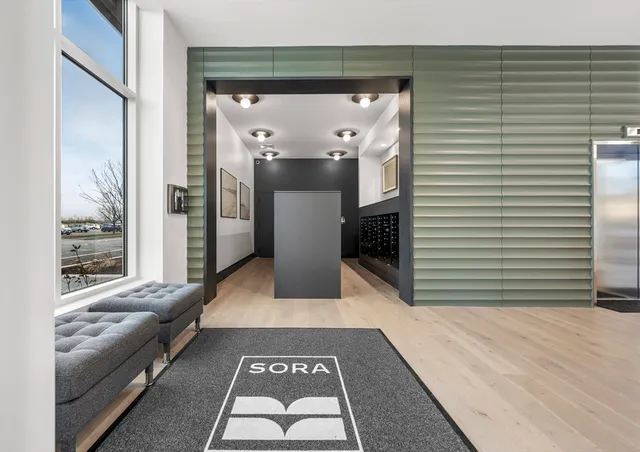 a lobby with furniture and a rug