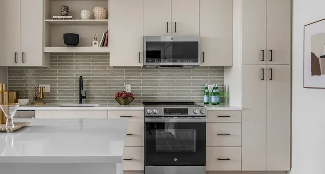 a kitchen with stainless steel appliances a stove and a microwave