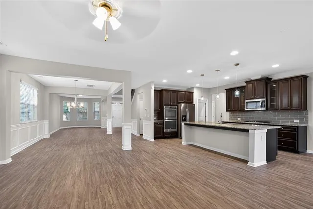 a view of kitchen with sink microwave and stove