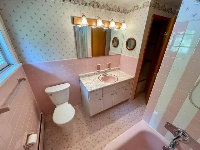 a bathroom with a sink a mirror and toilet