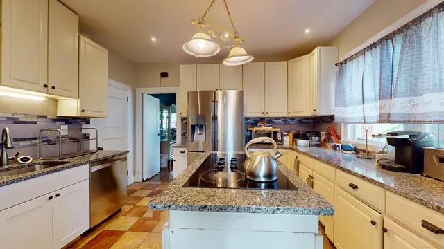 a kitchen with refrigerator a stove a sink cabinets and a counter top space