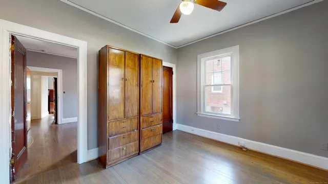 wooden floor in an empty room with a window