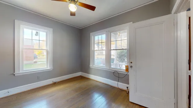 a view of wooden floor and windows in a room