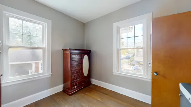 an empty room with windows and closet