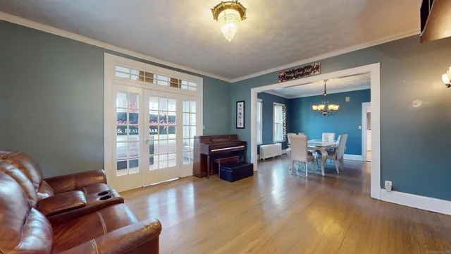 a living room with furniture and wooden floor