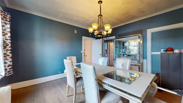 a view of a dining room with furniture and chandelier