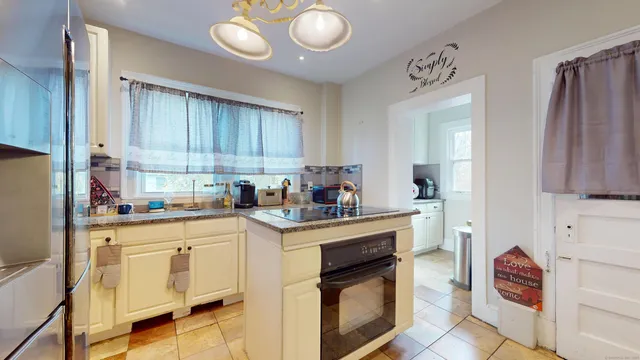 a kitchen with cabinets and chairs
