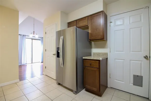 a kitchen with stainless steel appliances granite countertop a refrigerator and a stove