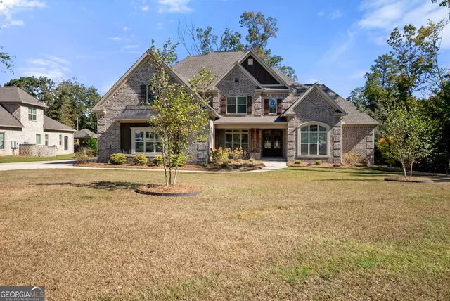 a front view of a building with a yard