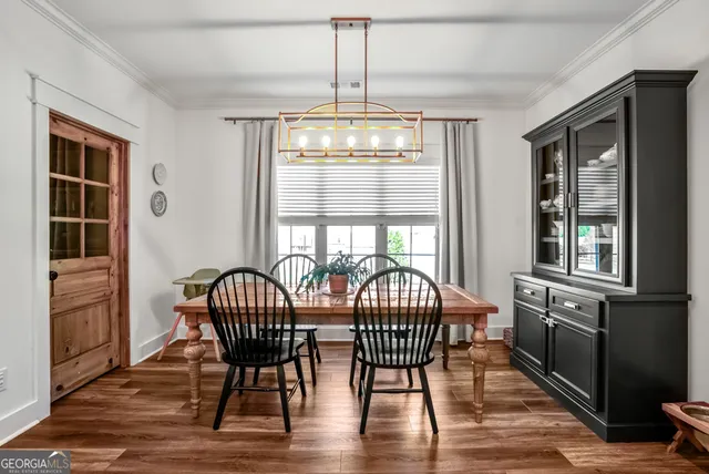 a view of a dining room with furniture window and wooden floor