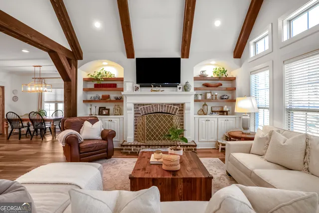 a living room with furniture fireplace and a flat screen tv
