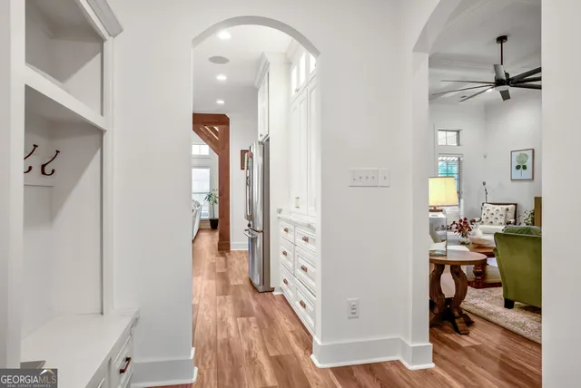 a view of a livingroom with wooden floor and a chandelier