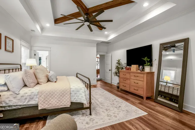 a bedroom with furniture and flat screen tv