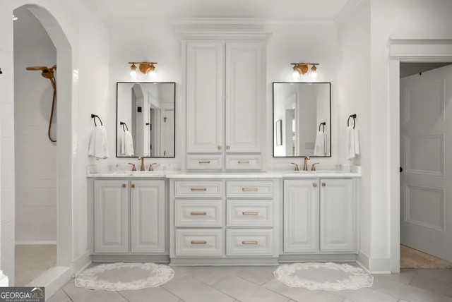 a bathroom with a sink vanity granite tub shower and a mirror