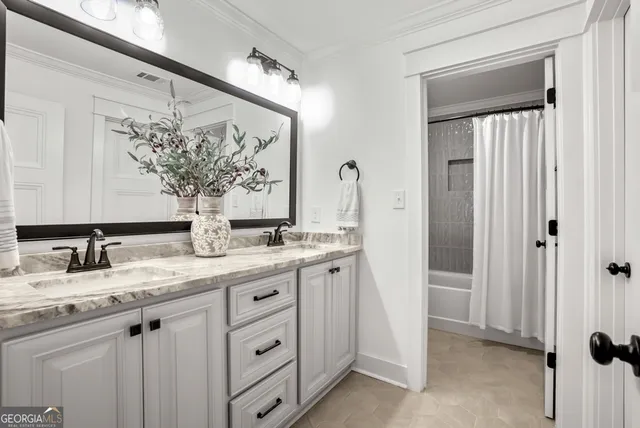 a bathroom with a granite countertop sink vanity mirror and a