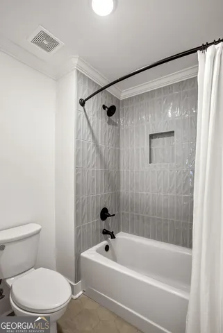 a white bath tub sitting next to a white toilet and sink