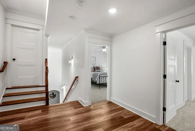 a view of a hallway to a livingroom with furniture