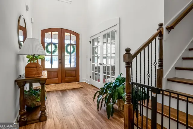 a view of an entryway with wooden floor and windows
