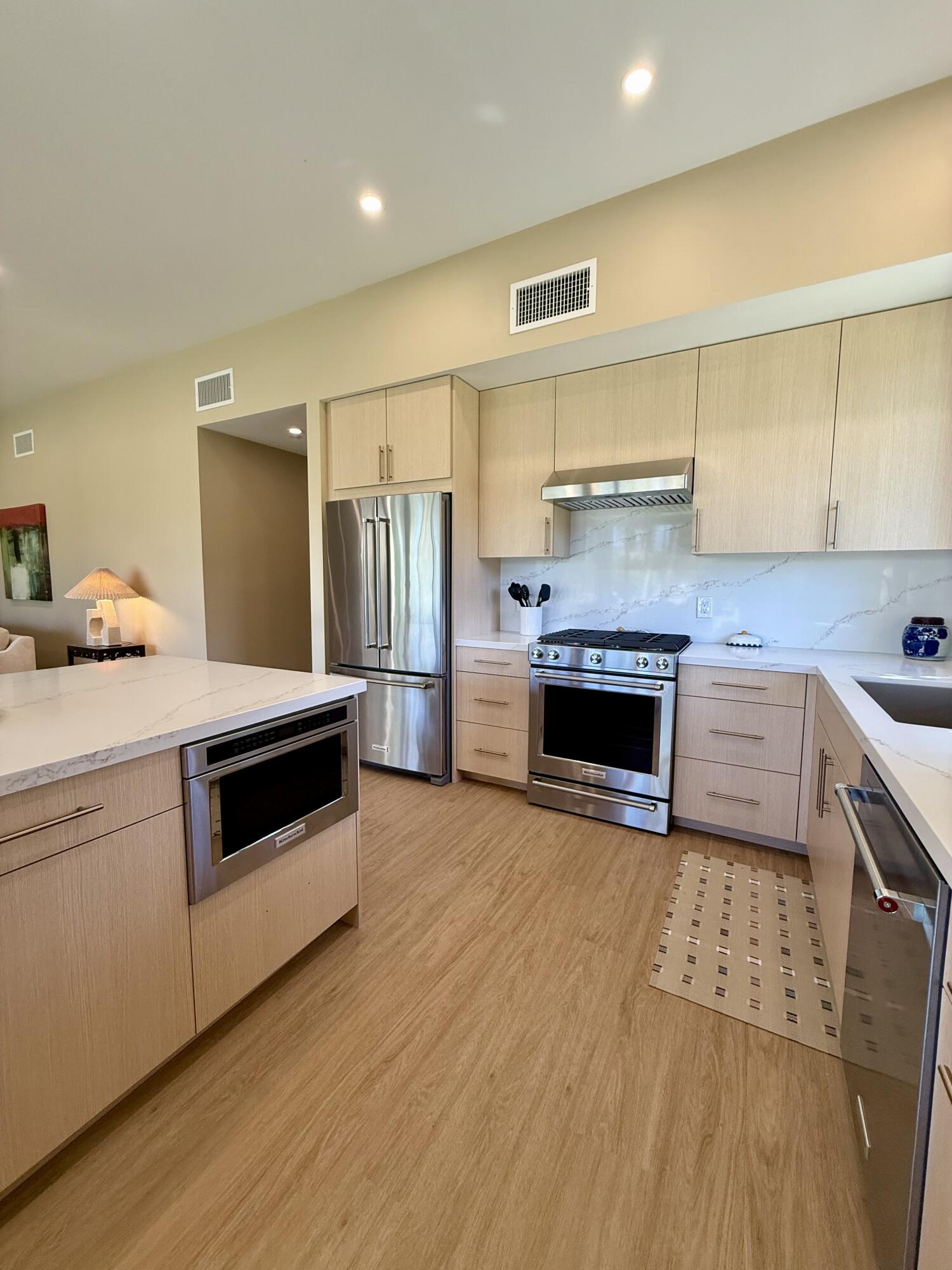 45565 Pima Road Indian Wells, CA 92210 - Photo 11 of 30 a kitchen with granite countertop a stove and a refrigerator