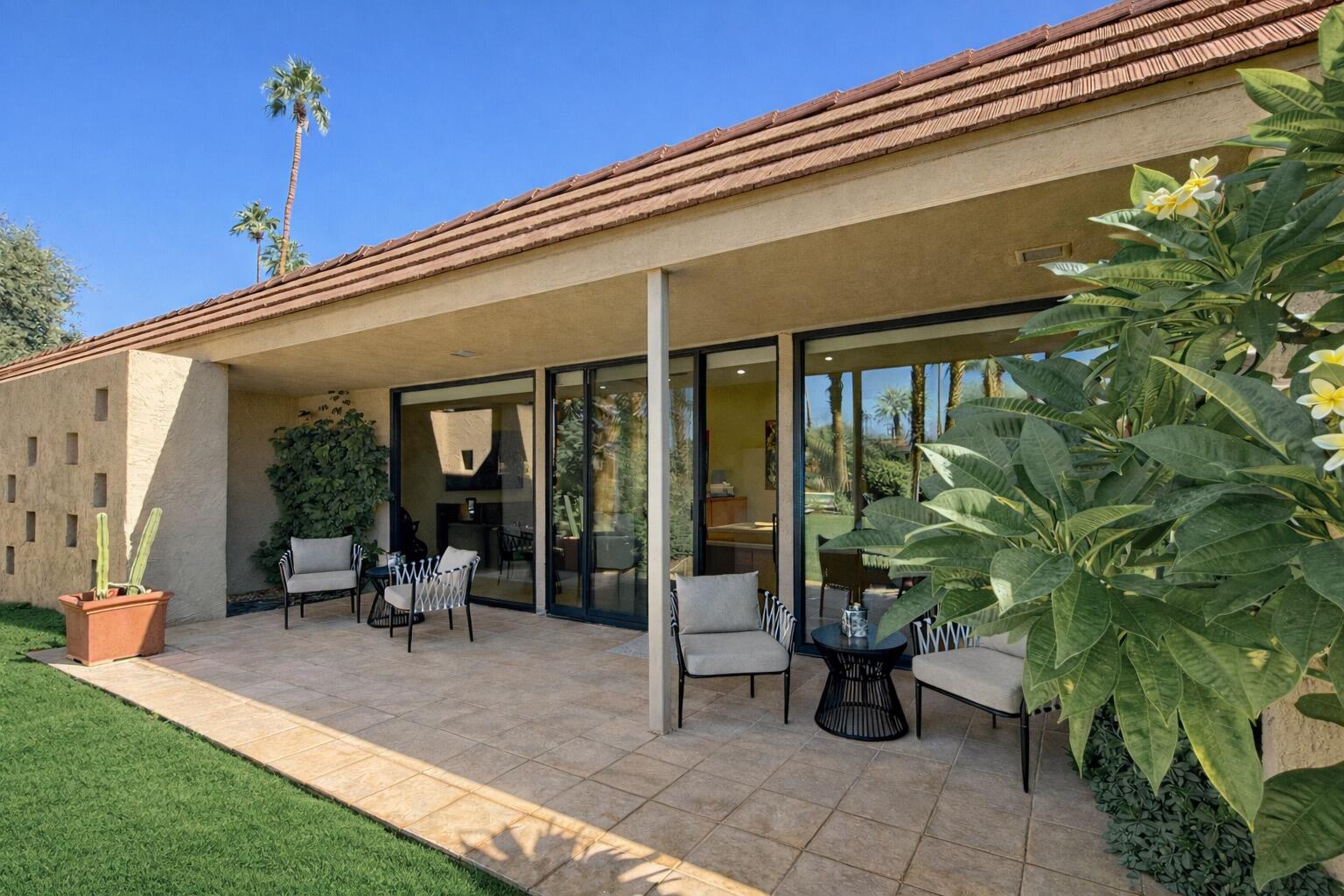 45565 Pima Road Indian Wells, CA 92210 - Photo 16 of 30 a view of a porch with chairs and floor to ceiling window