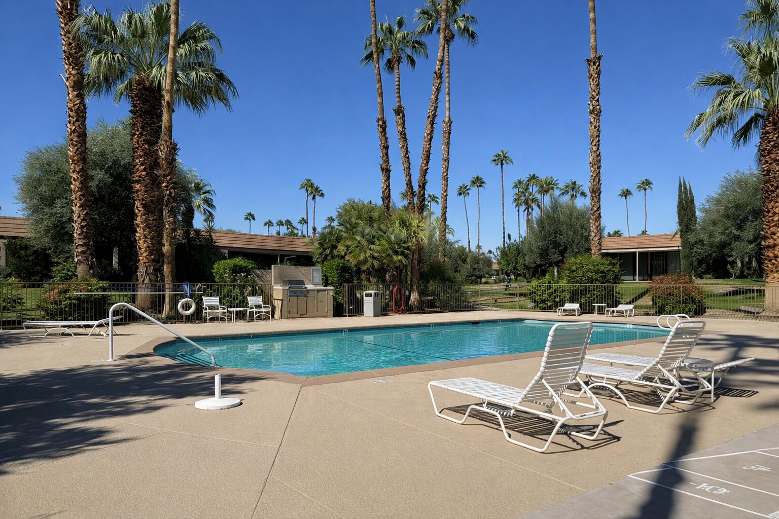 45565 Pima Road Indian Wells, CA 92210 - Photo 18 of 30 a view of a swimming pool with a patio and a yard
