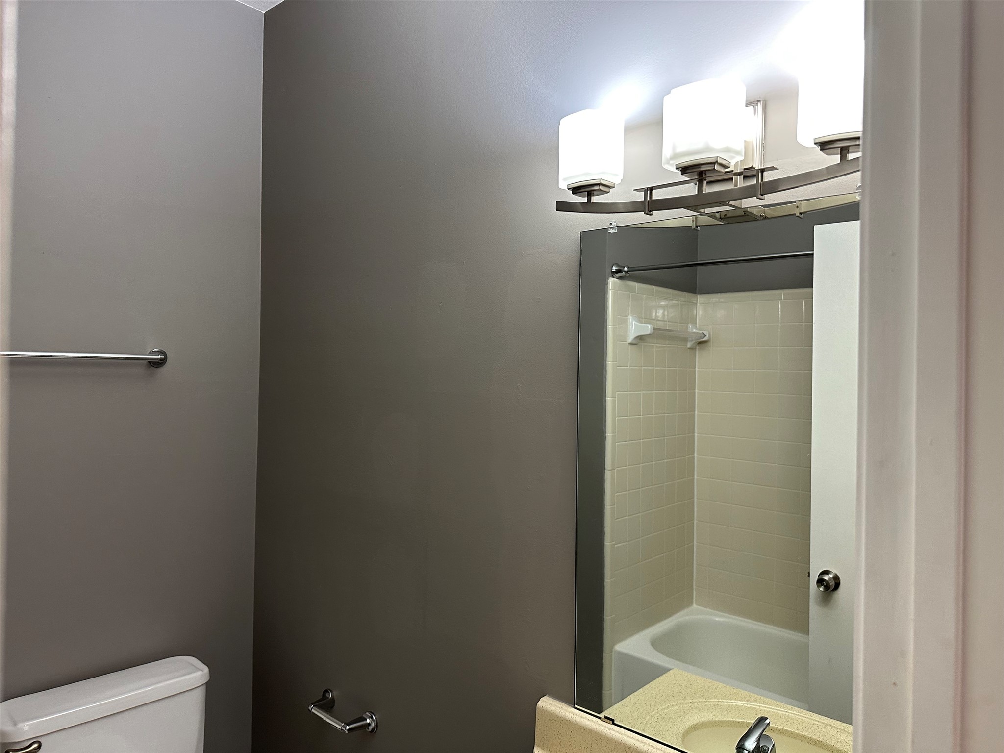 3800 Tanglewilde Street, Unit 504 Houston, TX 77063 - Photo 17 of 20 a bathroom with a granite countertop sink a toilet and shower