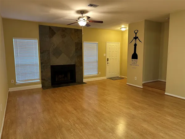 a view of empty room with a fireplace and fan