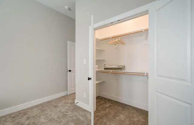 a room with a walk in closet and a window