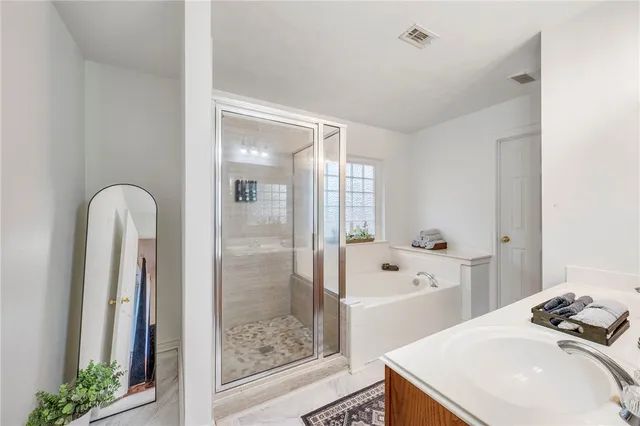 a bathroom with a sink a bathtub and a shower