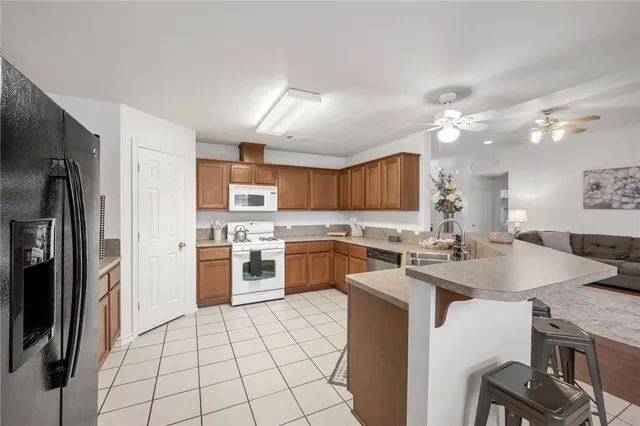 a kitchen with granite countertop a sink appliances cabinets and counter space