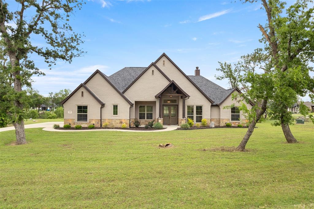 105 Clayton Crossing Springtown, TX 76082 - Photo 1 of 40 a front view of a house with a yard
