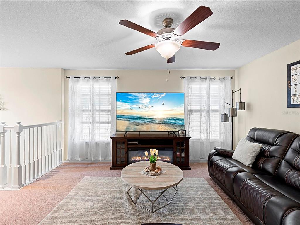 1716 Hadden Hall Place Trinity, FL 34655 - Photo 24 of 75 a living room with furniture a window and a ceiling fan