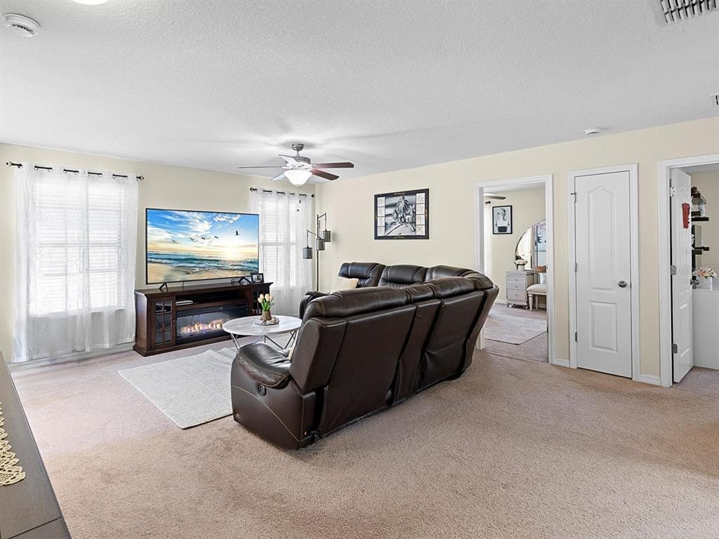 1716 Hadden Hall Place Trinity, FL 34655 - Photo 26 of 75 a living room with furniture and a flat screen tv