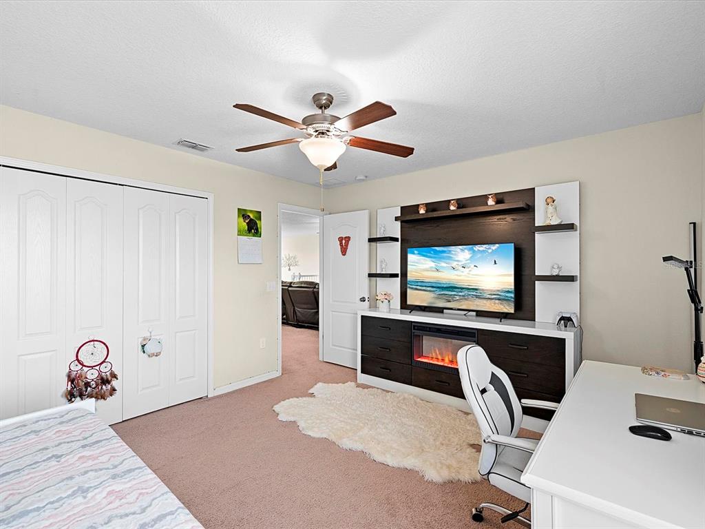 1716 Hadden Hall Place Trinity, FL 34655 - Photo 28 of 75 a bedroom with a bed and a flat screen tv