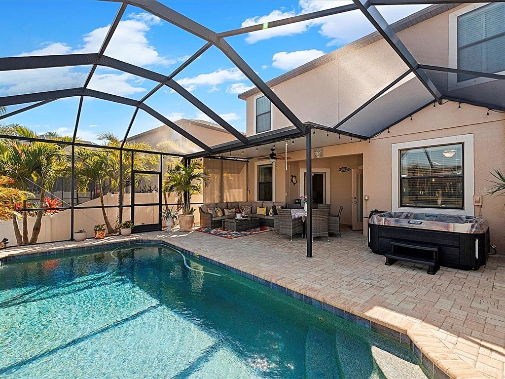 1716 Hadden Hall Place Trinity, FL 34655 - Photo 38 of 75 a backyard of a house with barbeque oven table and chairs