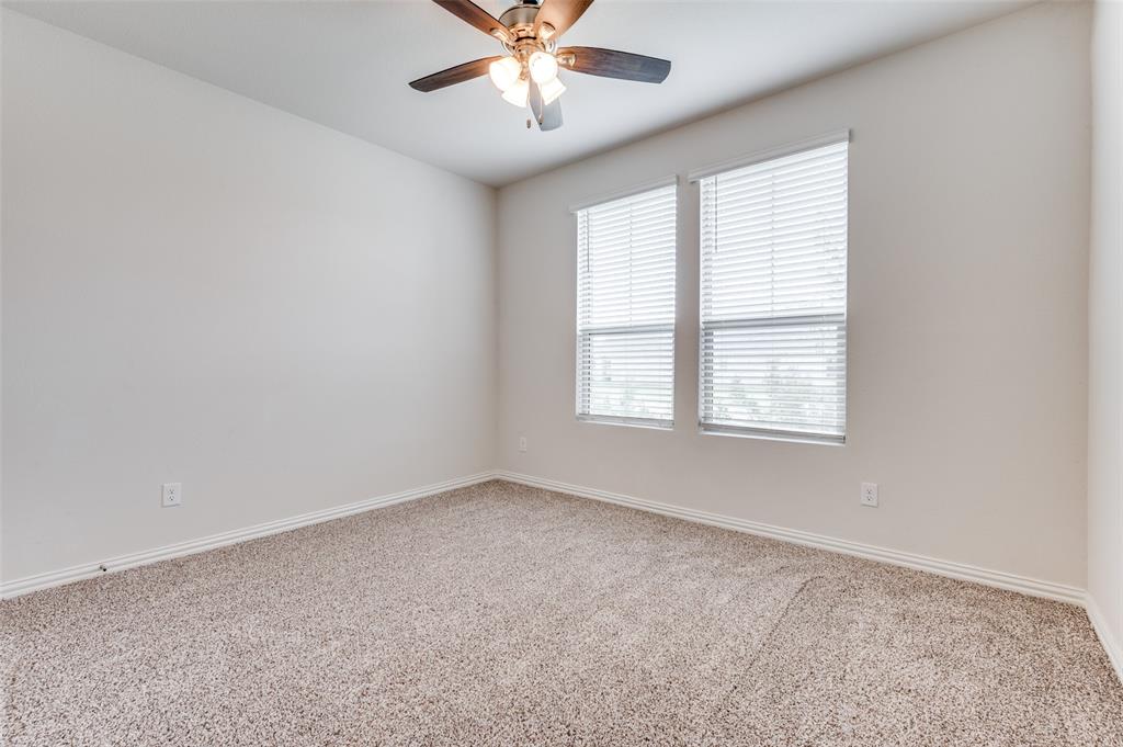 3308 Kingsdown Drive Denton, TX 76207 - Photo 17 of 25 an empty room with windows and fan