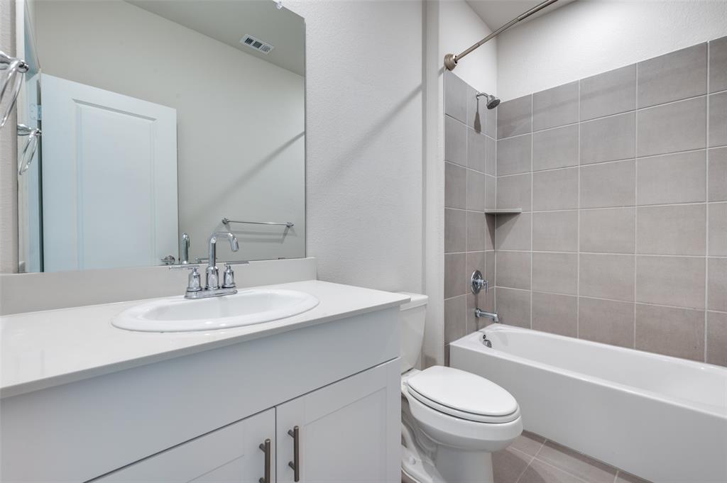 3308 Kingsdown Drive Denton, TX 76207 - Photo 18 of 25 a bathroom with a sink toilet and shower