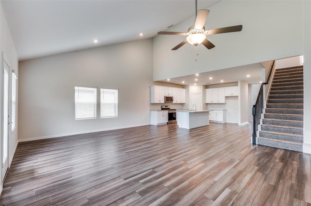 3308 Kingsdown Drive Denton, TX 76207 - Photo 5 of 25 a view of an empty room with wooden floor and a ceiling fan