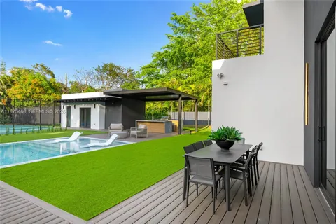 a view of a backyard with sitting area