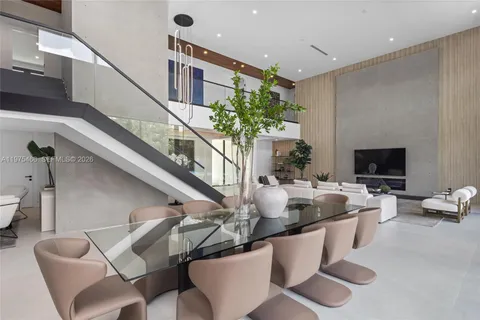 a kitchen with stainless steel appliances kitchen island granite countertop a table and chairs in it