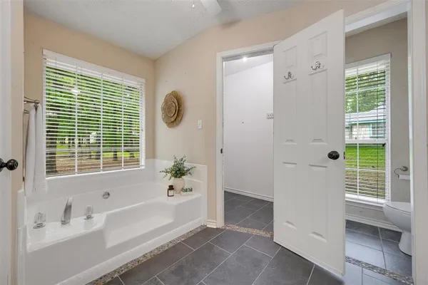 a spacious bathroom with a bathtub and a shower
