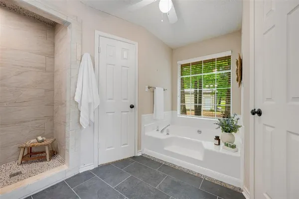 a bathroom with a granite countertop sink a large mirror and a shower