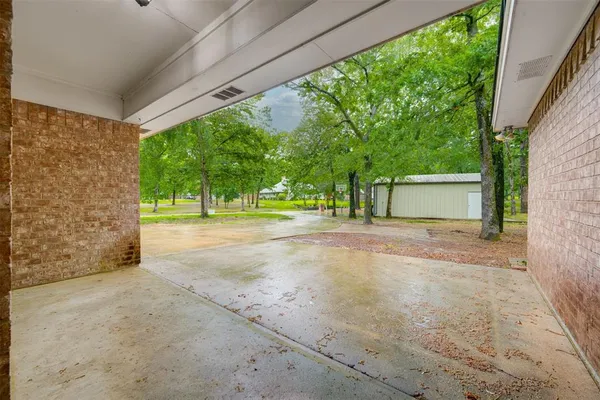 a backyard of a house with wooden floor and fence