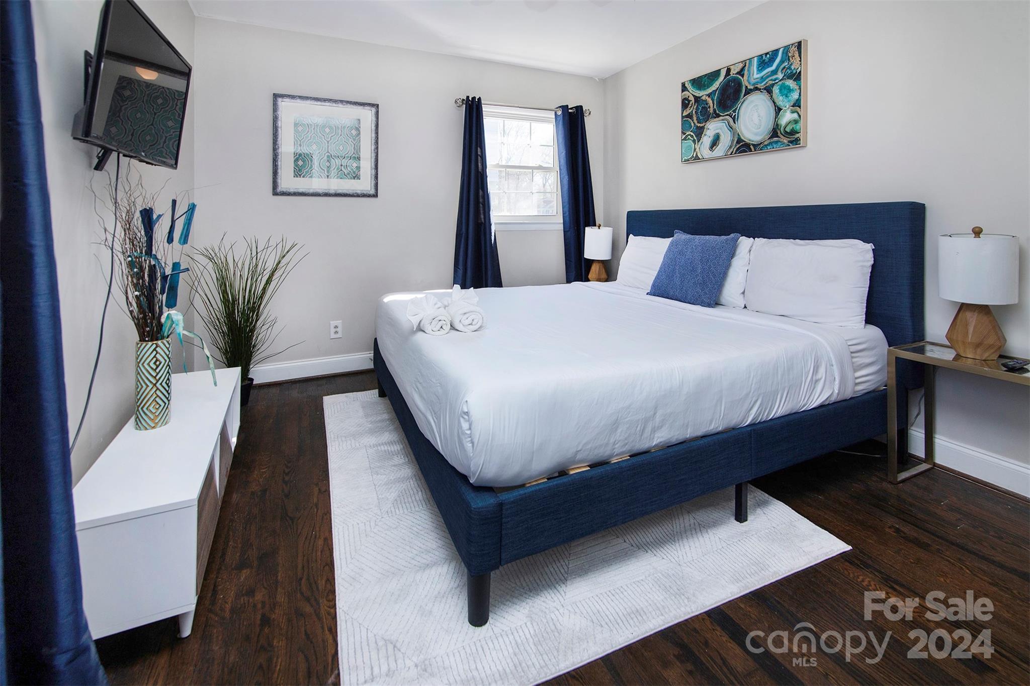 3741 Woodleaf Road Charlotte, NC 28205 - Photo 11 of 31 a bed sitting in a bedroom next to a window