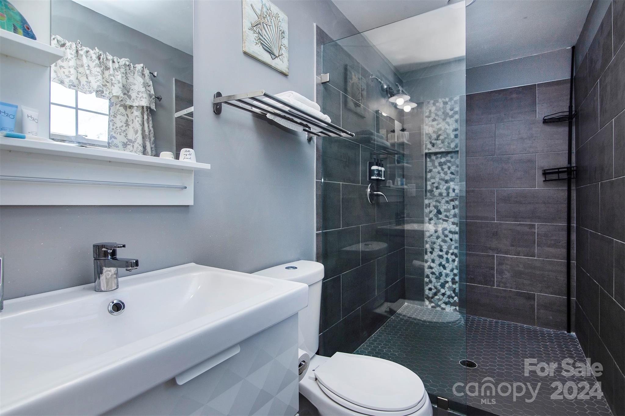 3741 Woodleaf Road Charlotte, NC 28205 - Photo 12 of 31 a bathroom with a sink toilet and shower