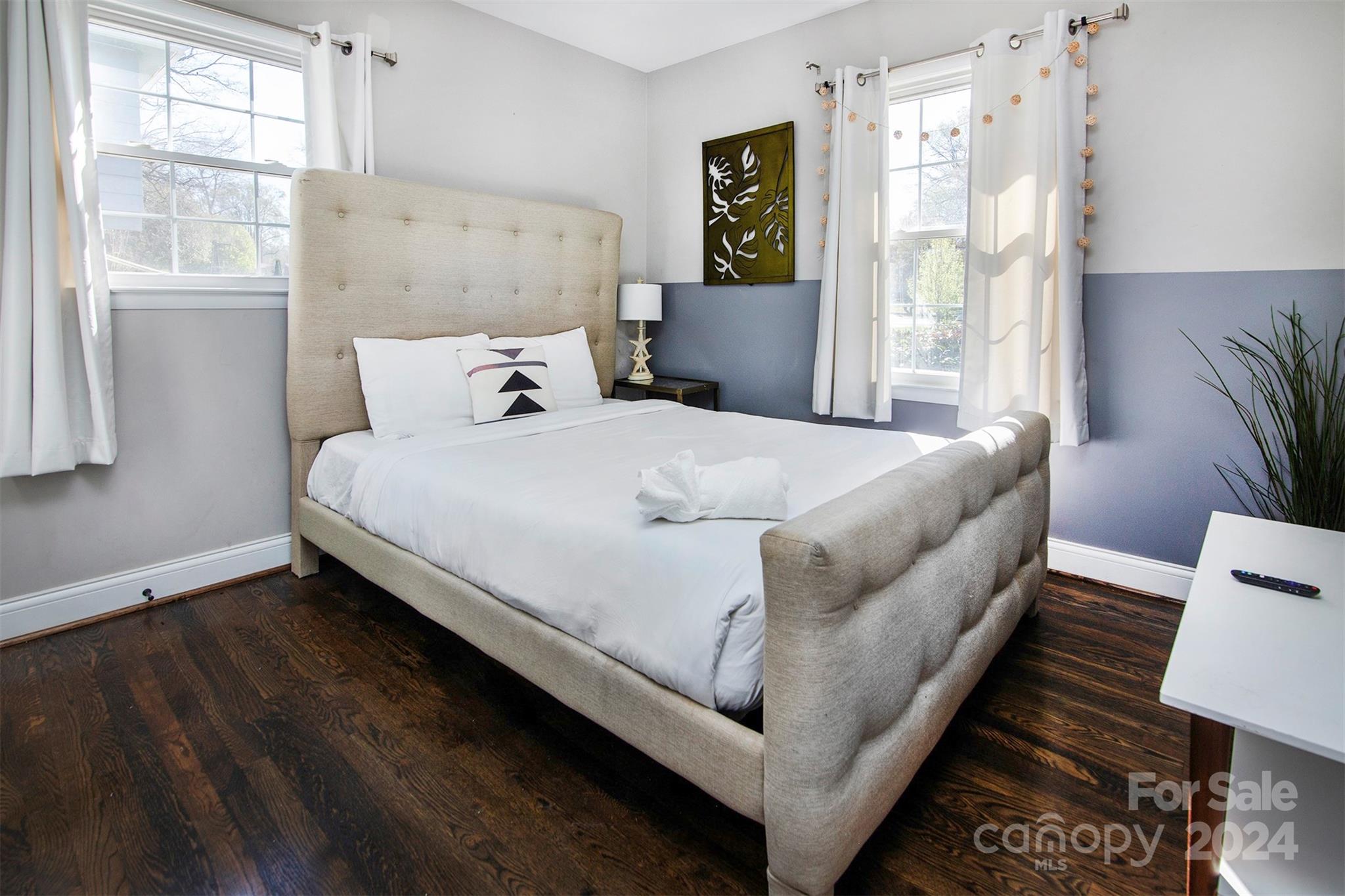 3741 Woodleaf Road Charlotte, NC 28205 - Photo 14 of 31 a bed sitting in a bedroom next to a window