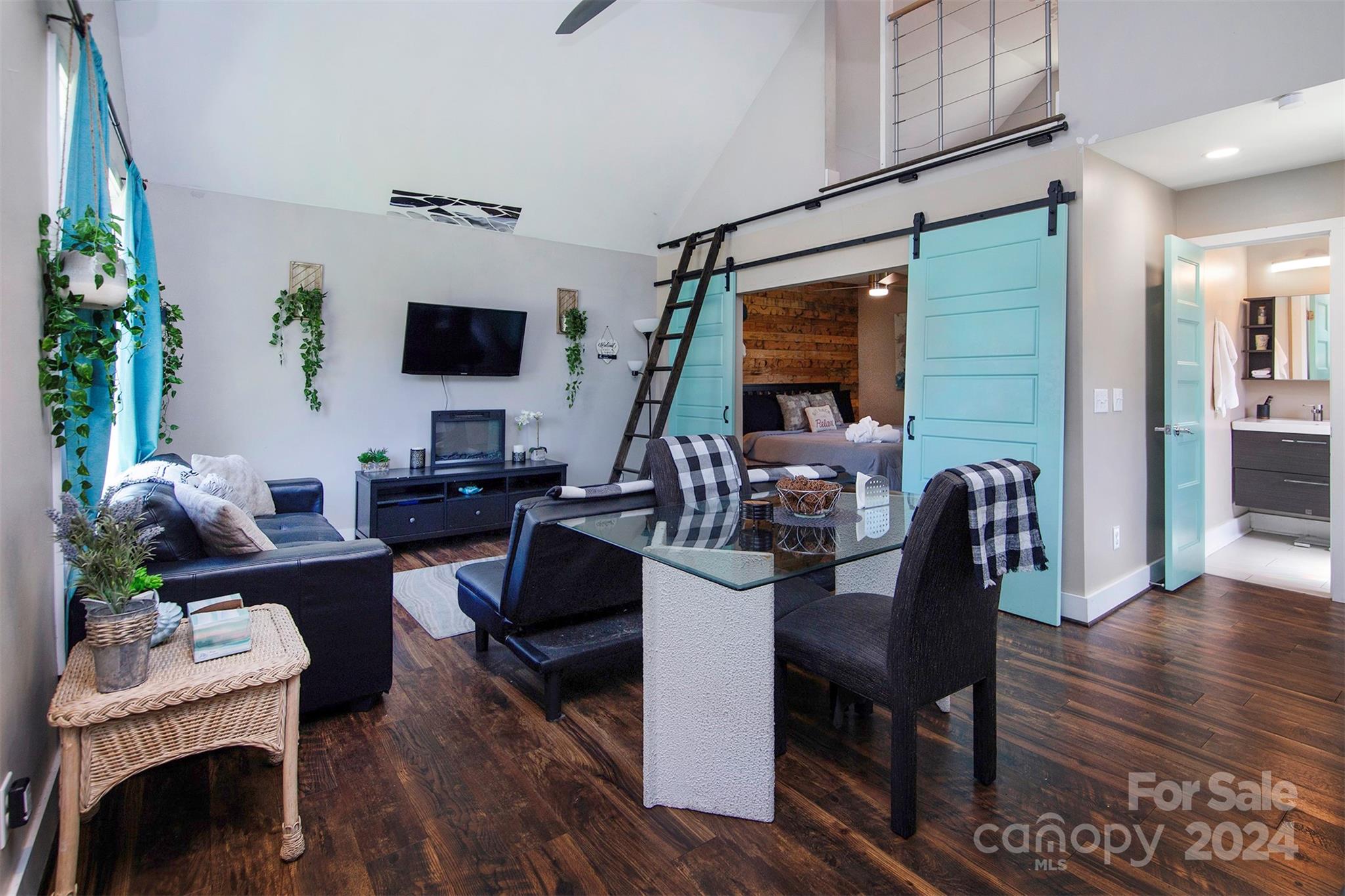 3741 Woodleaf Road Charlotte, NC 28205 - Photo 20 of 31 a living room with furniture a flat screen tv and a large window
